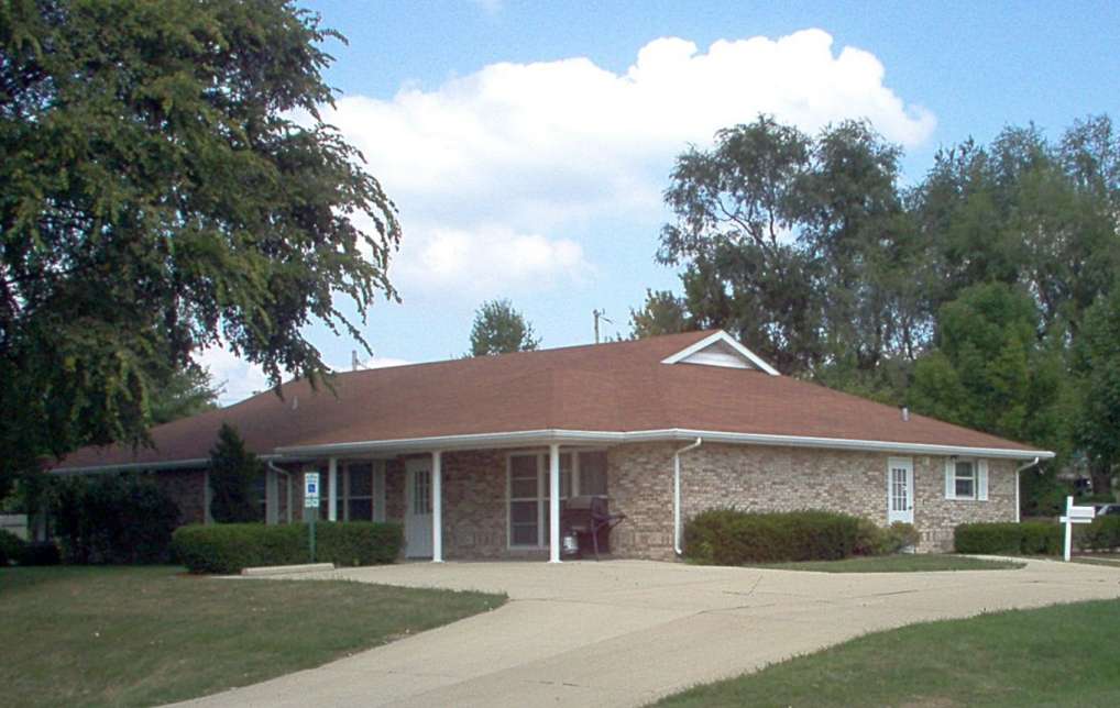 single story home and driveway in a residential suburb type neighborhood